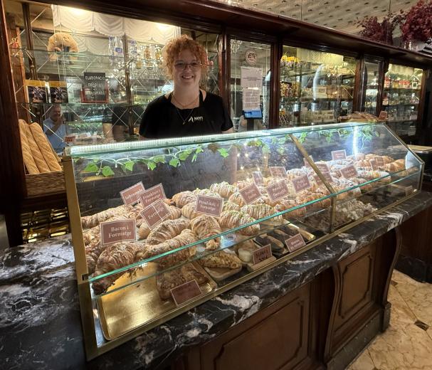 Anna, entre su mostrador y el expositor de sobremesa. Rodeada de parte de lo que ha hecho esa misma mañana.
