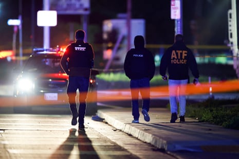 three police officers walk along a street